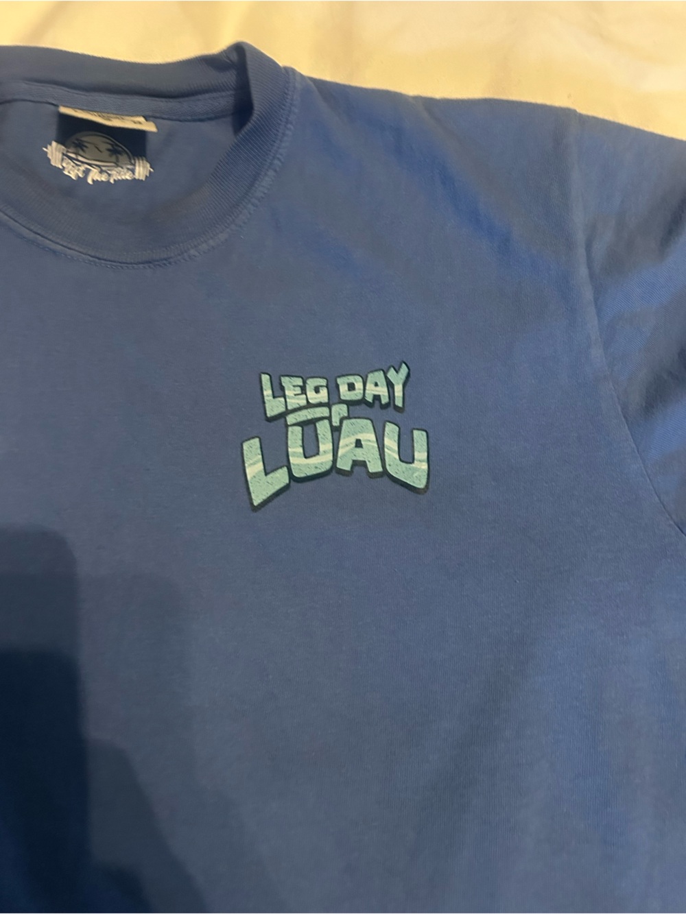 Blue Graphic Tee with Light Blue “Leg Day Lou” Logo